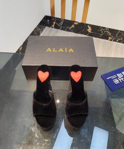 ALAIA's latest hate sky high water table slippers for 2024, with a unique heart-shaped desig8uq29nlv