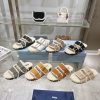 Prada slippers feature a soft lining and an iconic triangular logo, showcasing a unique binaalrkwdar