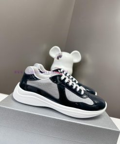 Prada Top Edition SneakersImported fly woven fabric with stitched patent leather on the uppera5vyvtj
