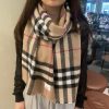 Burberry's classic cashmere plaid scarf with short beard edge is a must-have for the fragranjdvil2jb