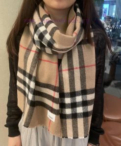 Burberry's classic cashmere plaid scarf with short beard edge is a must-have for the fragranjdvil2jb