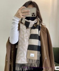 The beige double-sided scarf features the latest Tb print on one side and a classic checkereax03gjed